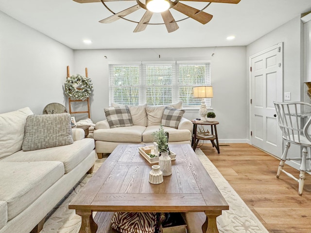 living room with light wood-type flooring and ceiling fan