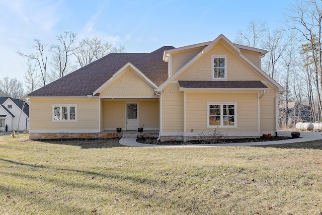 rear view of property featuring a yard