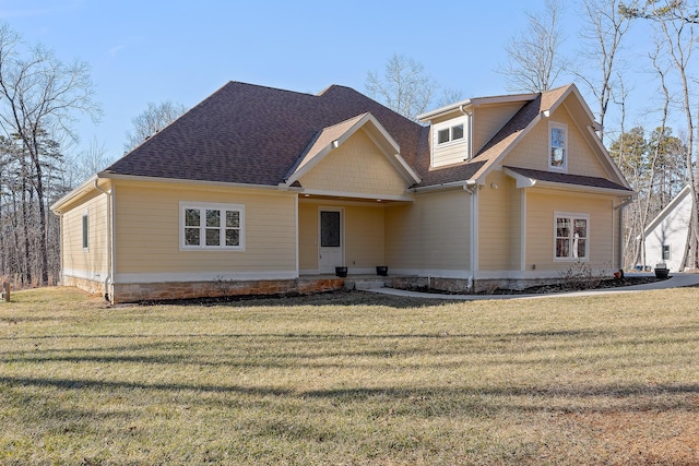 craftsman-style home with a front yard