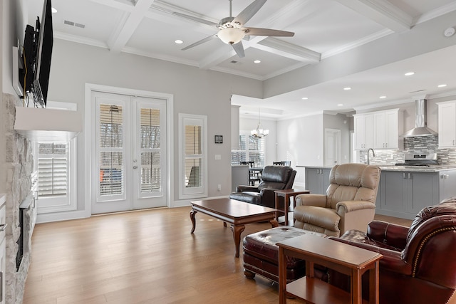 living room featuring french doors, coffered ceiling, beam ceiling, and light wood-type flooring