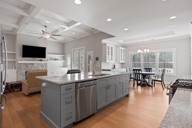 kitchen with appliances with stainless steel finishes, pendant lighting, sink, gray cabinetry, and light hardwood / wood-style floors