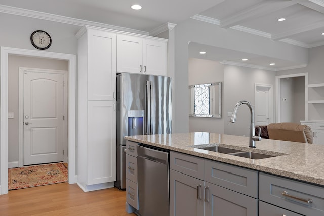 kitchen with white cabinetry, sink, gray cabinetry, stainless steel appliances, and light stone countertops