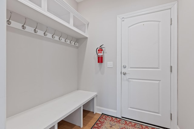 mudroom featuring light wood-style flooring and baseboards