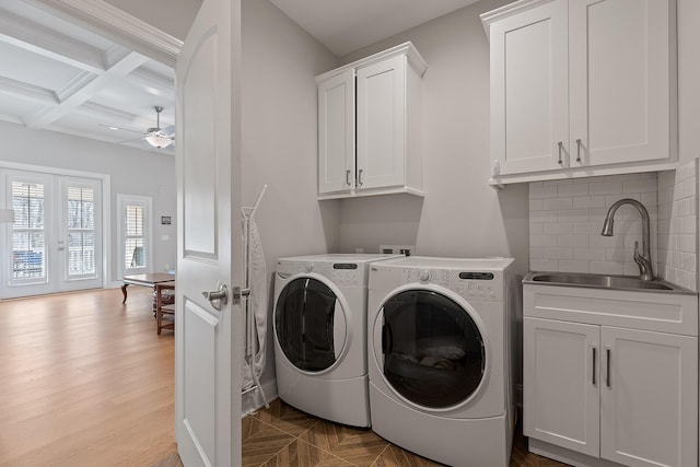 clothes washing area with french doors, sink, cabinets, ceiling fan, and independent washer and dryer