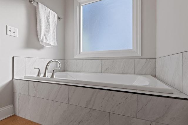 bathroom featuring a relaxing tiled tub