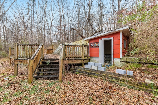 wooden terrace featuring a storage shed