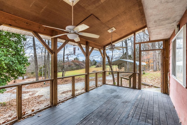 unfurnished sunroom featuring a wealth of natural light, ceiling fan, and wooden ceiling