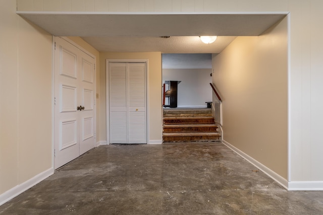 stairs featuring concrete flooring