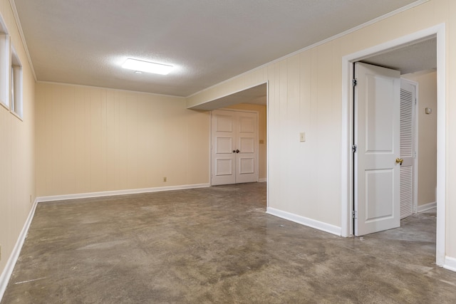 empty room with crown molding, concrete flooring, and a textured ceiling