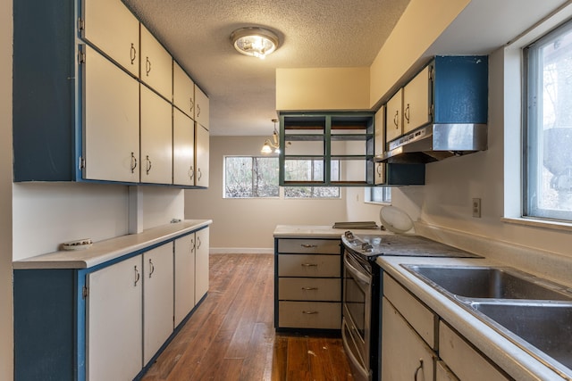 kitchen with a textured ceiling, dark wood-type flooring, sink, white cabinets, and stainless steel range with electric cooktop