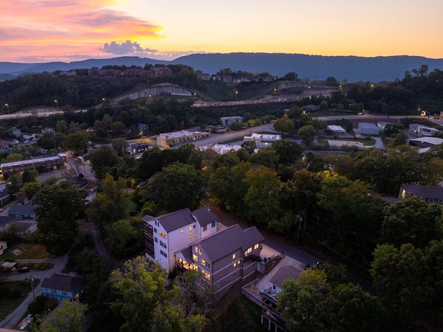 aerial view at dusk featuring a mountain view