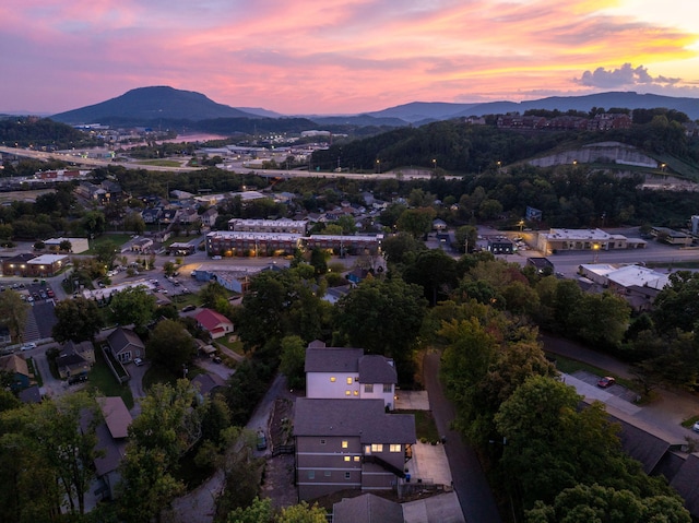 aerial view at dusk featuring a mountain view