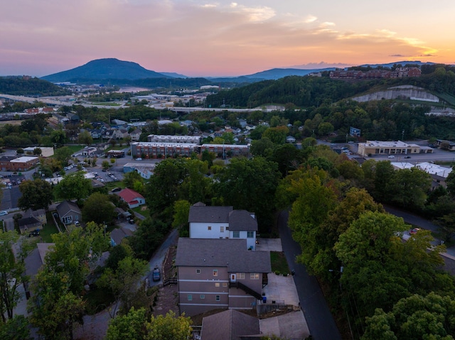 aerial view at dusk featuring a mountain view