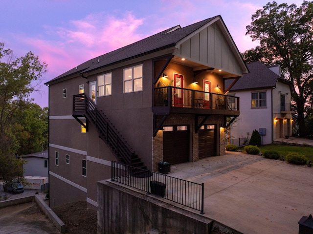 view of front of house featuring a garage and a balcony