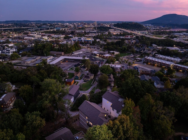 aerial view at dusk featuring a mountain view