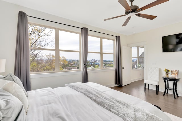 bedroom with ceiling fan and dark wood-type flooring