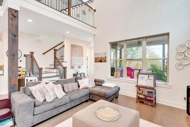 living room with hardwood / wood-style flooring and a high ceiling