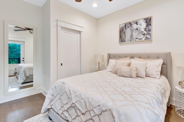 bedroom with ceiling fan and dark hardwood / wood-style flooring