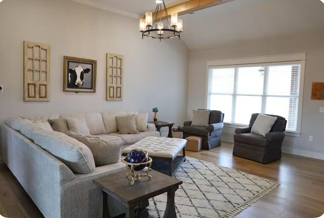 living room with a notable chandelier, wood-type flooring, and plenty of natural light