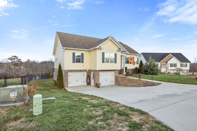 split foyer home featuring a front yard and a garage