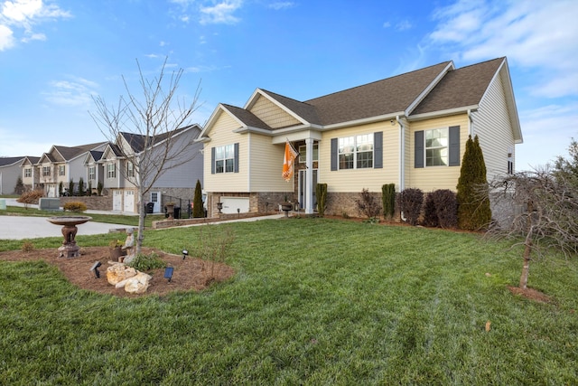 view of front of house with a garage and a front lawn