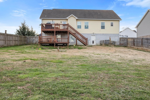 rear view of property featuring a lawn and a wooden deck