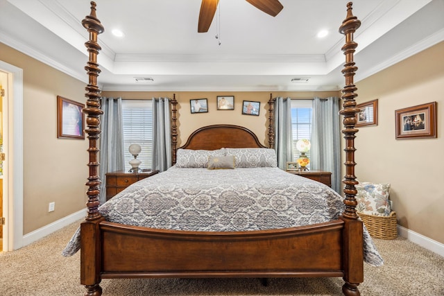 bedroom with carpet floors, a raised ceiling, ceiling fan, and crown molding