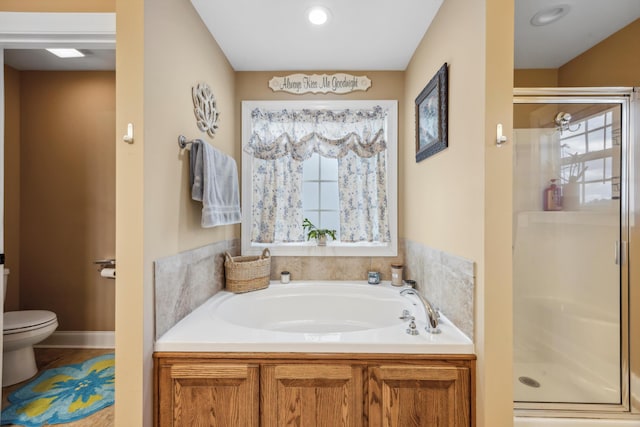 bathroom featuring toilet and independent shower and bath