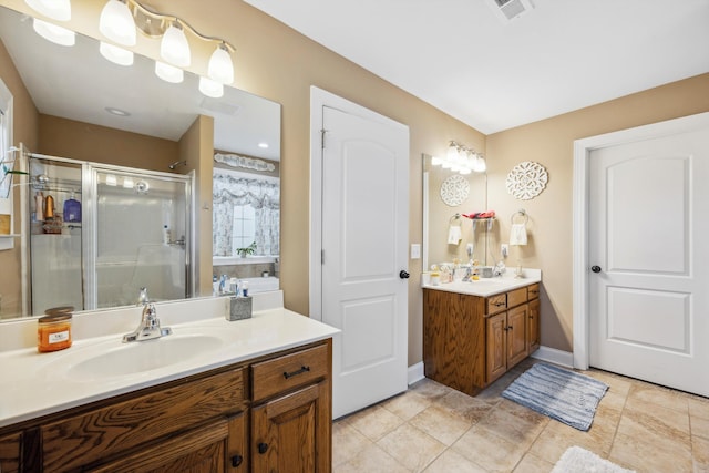 bathroom featuring vanity and a shower with shower door