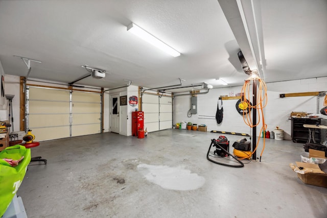 garage featuring electric panel and a garage door opener