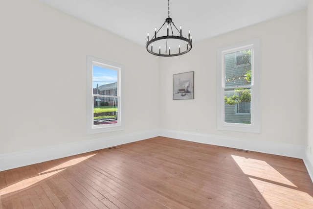 802 E Martin Luther King Blvd, Chattanooga, TN 37403 - empty room featuring a chandelier, plenty of natural light, and hardwood / wood-style floors