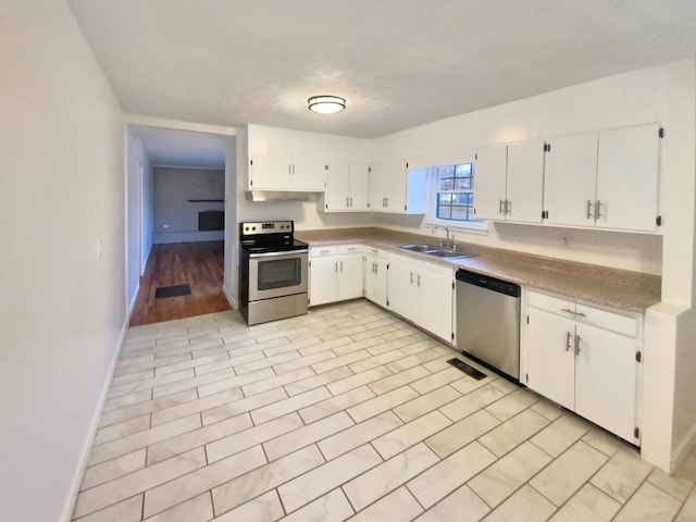 kitchen featuring light tile patterned flooring, sink, white cabinetry, and stainless steel appliances