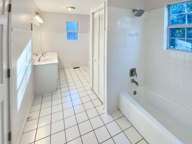 bathroom featuring tile patterned floors, plenty of natural light, vanity, and tiled shower / bath