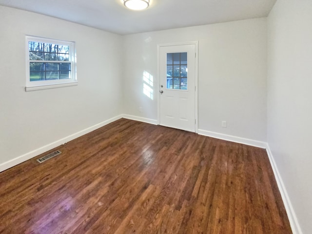 spare room featuring dark hardwood / wood-style floors