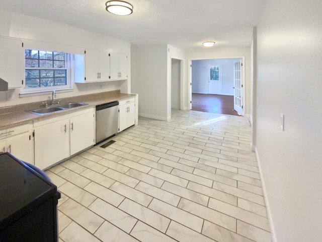 kitchen with white cabinets, stainless steel dishwasher, black range with electric stovetop, and sink