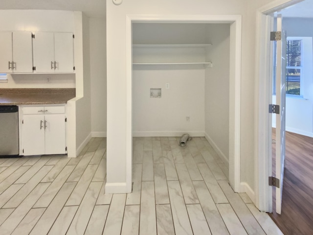 clothes washing area featuring washer hookup and light hardwood / wood-style flooring