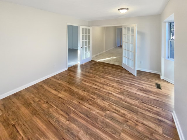 spare room with wood-type flooring and french doors