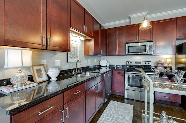 kitchen with sink, stainless steel appliances, dark stone counters, pendant lighting, and ornamental molding