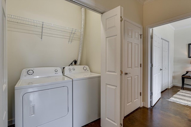 laundry area with separate washer and dryer and crown molding