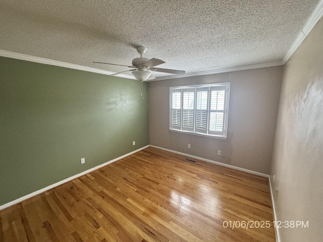 empty room featuring ceiling fan, ornamental molding, a textured ceiling, and light hardwood / wood-style flooring