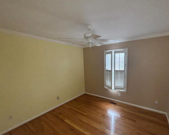 spare room with ceiling fan, crown molding, and light hardwood / wood-style floors