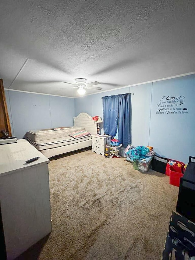 carpeted bedroom featuring ceiling fan and a textured ceiling