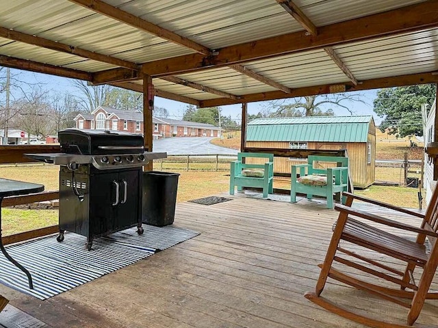 deck featuring area for grilling and a lawn