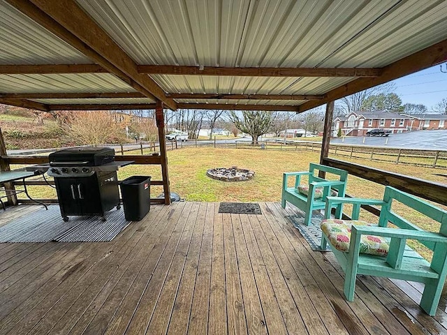 deck with a fire pit and a lawn