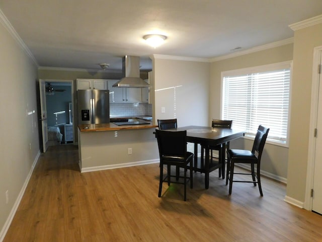 dining area with hardwood / wood-style flooring, ceiling fan, and crown molding