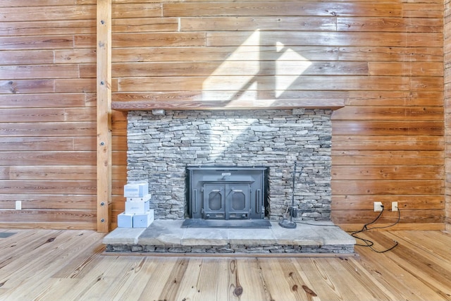 details with wooden walls and a wood stove