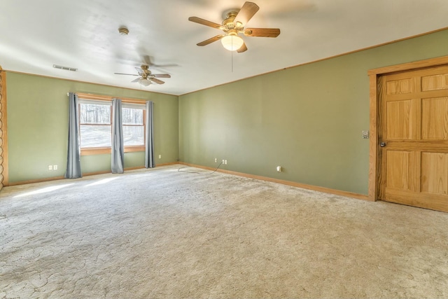 carpeted spare room featuring ceiling fan