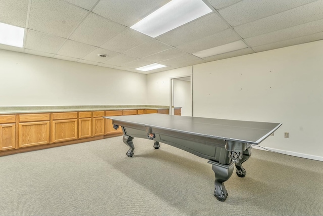 playroom featuring a paneled ceiling and light carpet