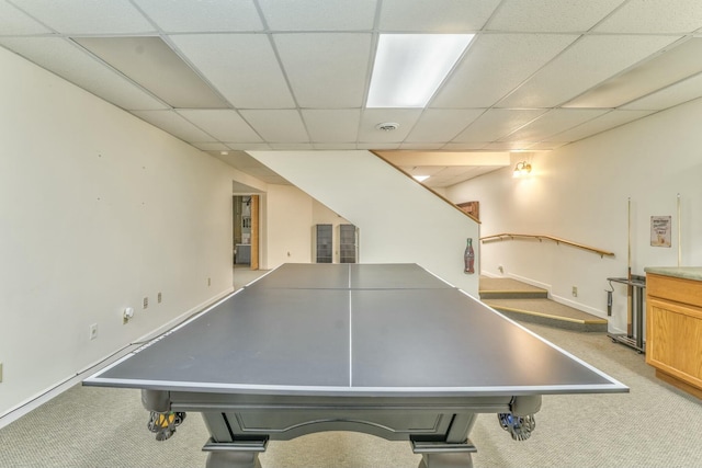 rec room featuring a paneled ceiling and carpet