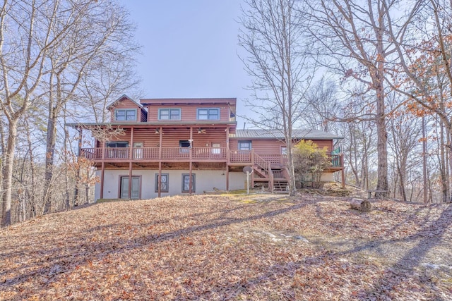 rear view of property featuring a wooden deck